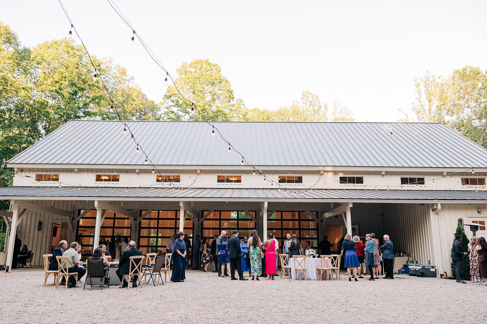 A wide look at a carolina grove wedding venue reception outside on the patio