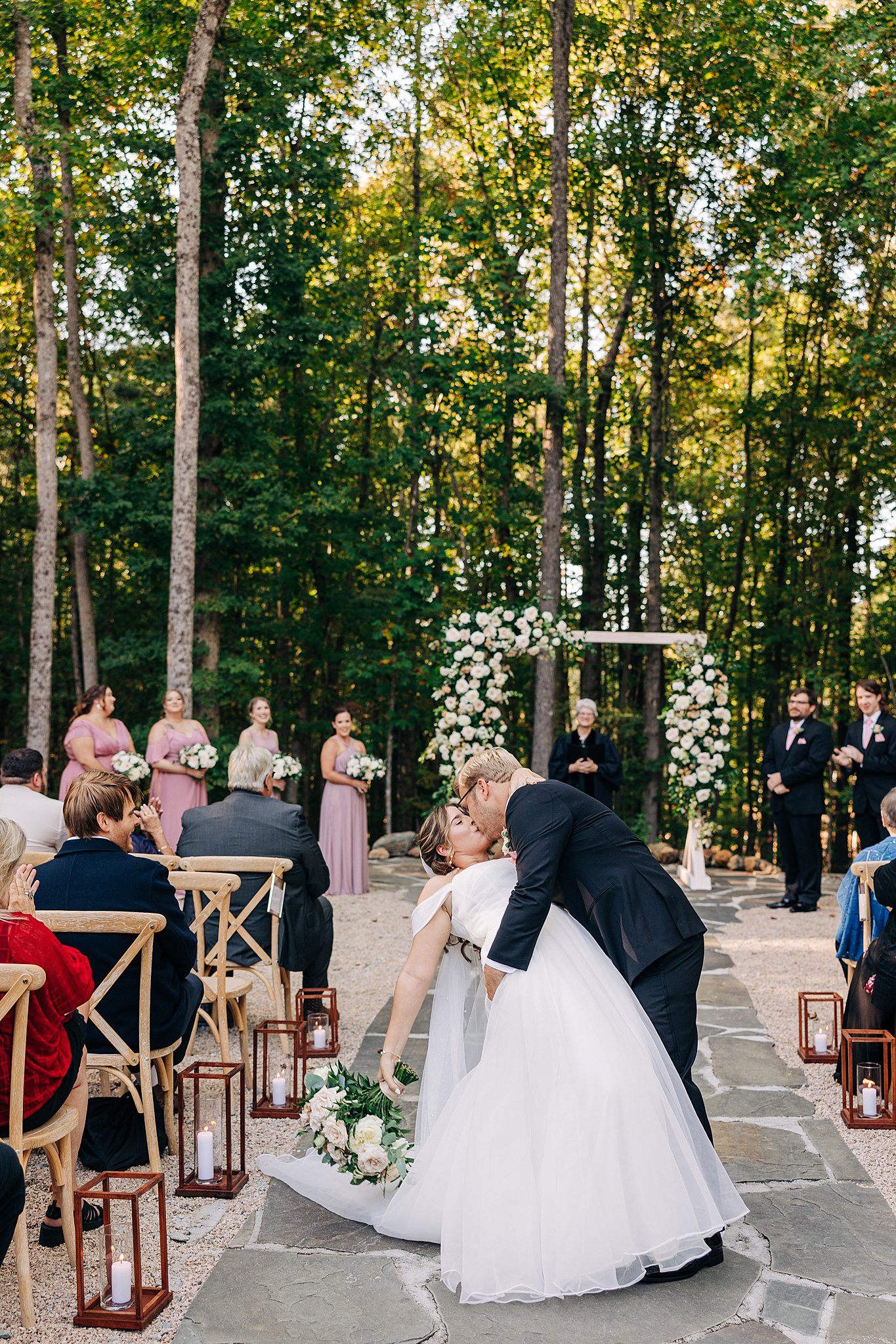 Newlyweds dip and kiss in the aisle after their carolina grove wedding venue ceremony