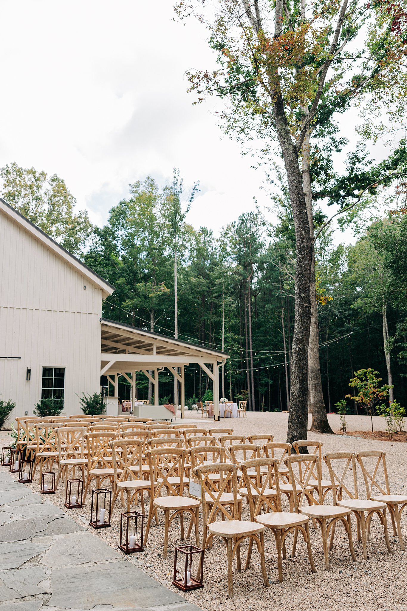 Details of an outdoor wedding ceremony set up with wooden chairs