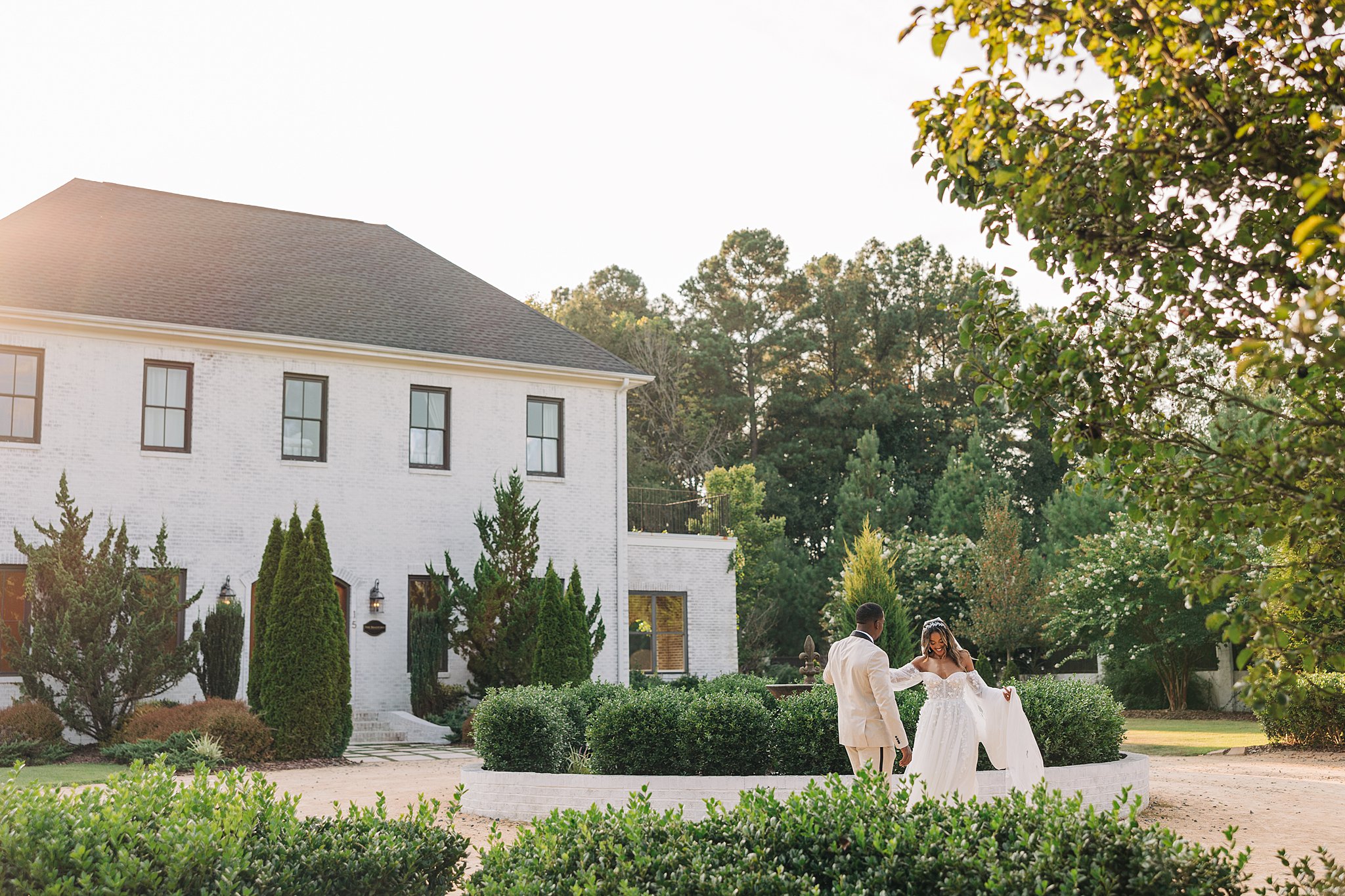 Newlyweds dance in a garden patio at sunset at the bradford wedding venue