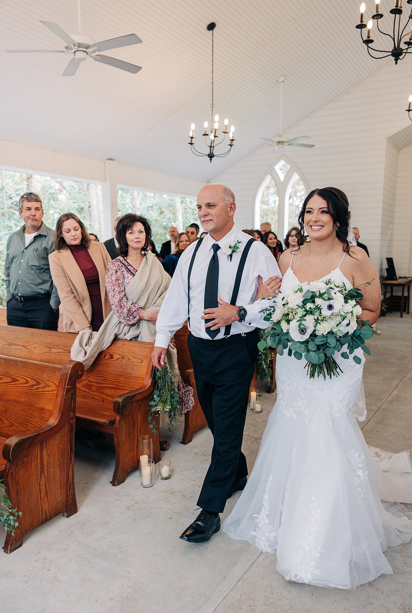 A father walks his daughter down the aisle for her wedding