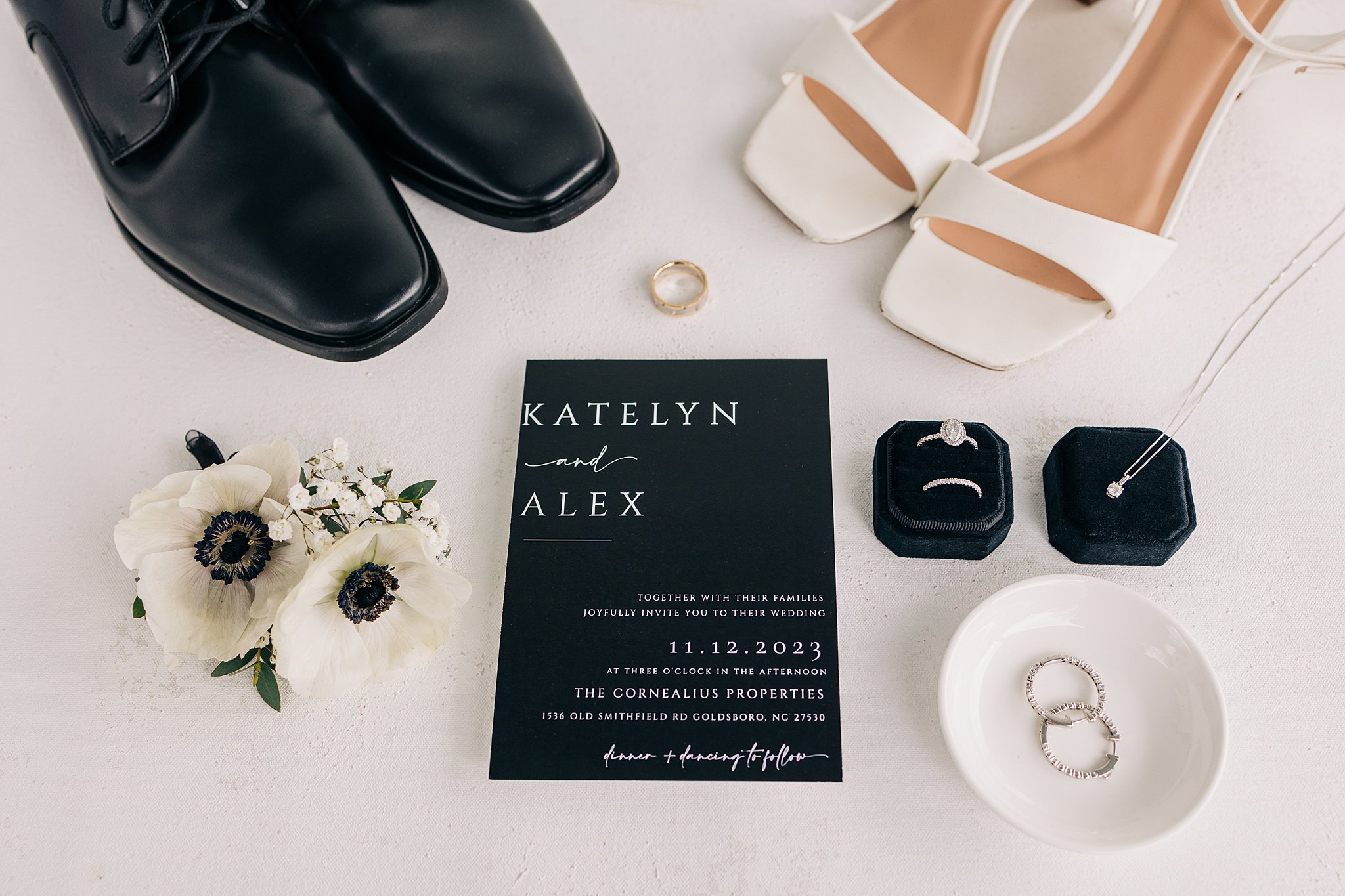 Details of a wedding with shoes, jewelry and an invitation