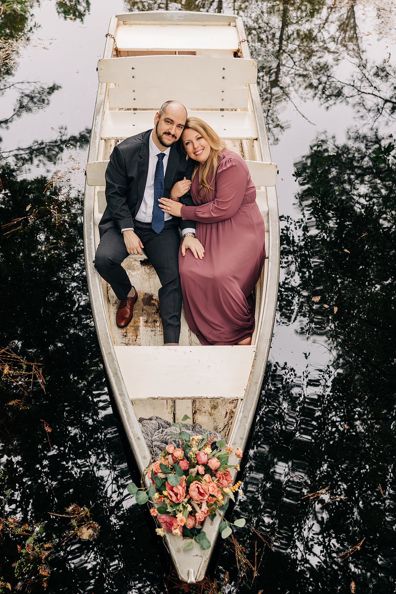 A view down onto a couple in a small boat during their cypress gardens wedding engagement