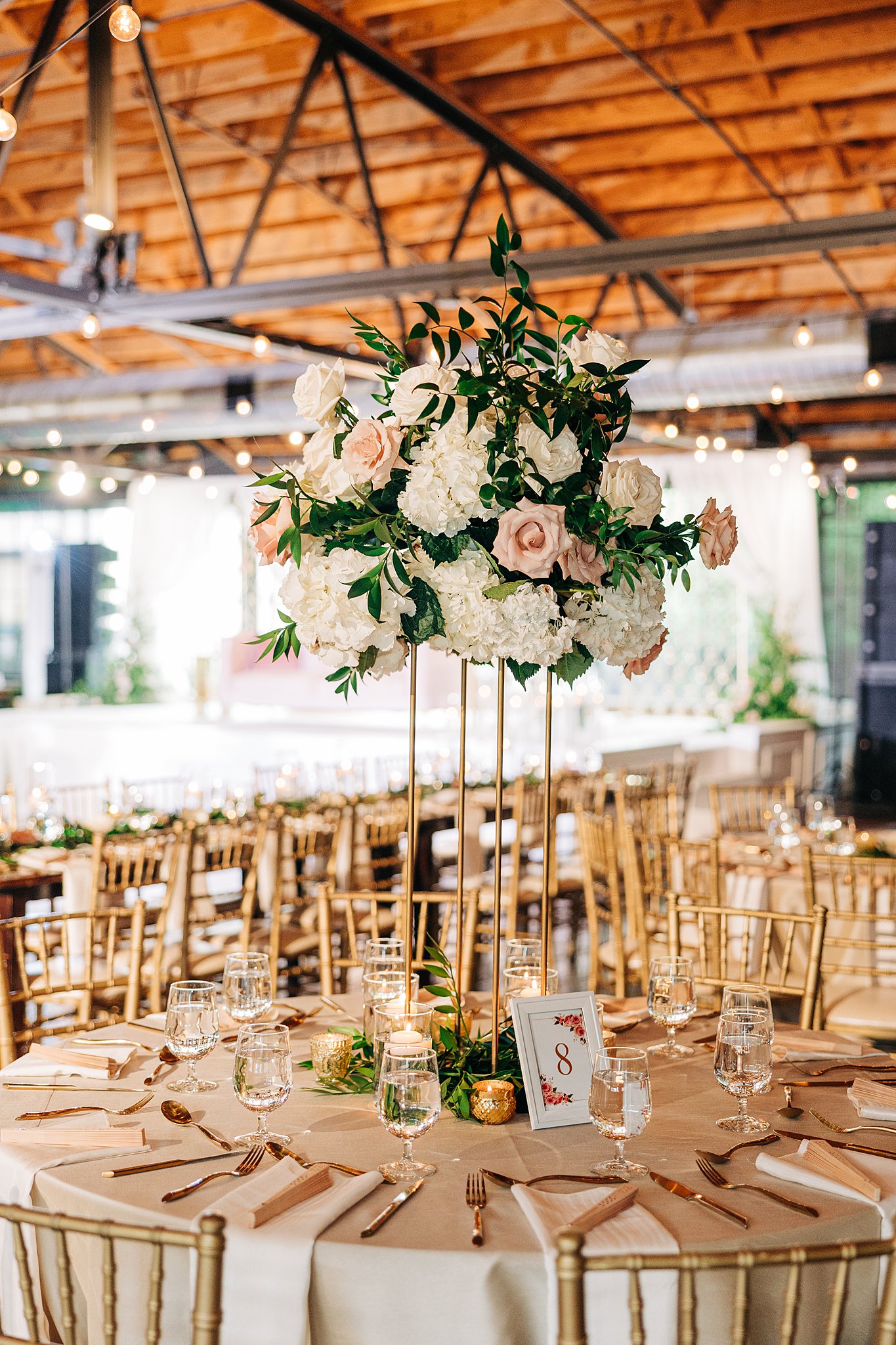 A view of a tall floral centerpiece at a wedding reception table