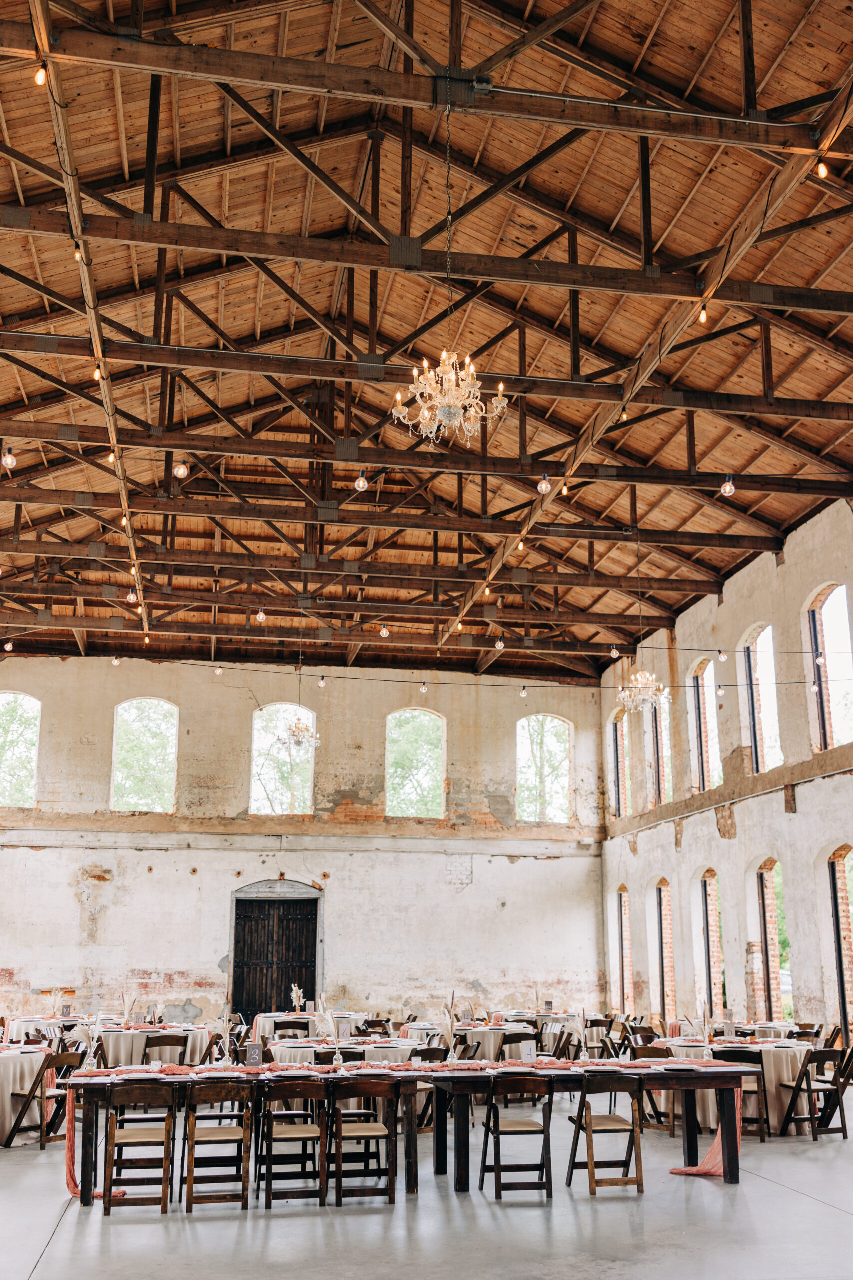 A view of a Providence Cotton Mill wedding reception set up with wooden chairs