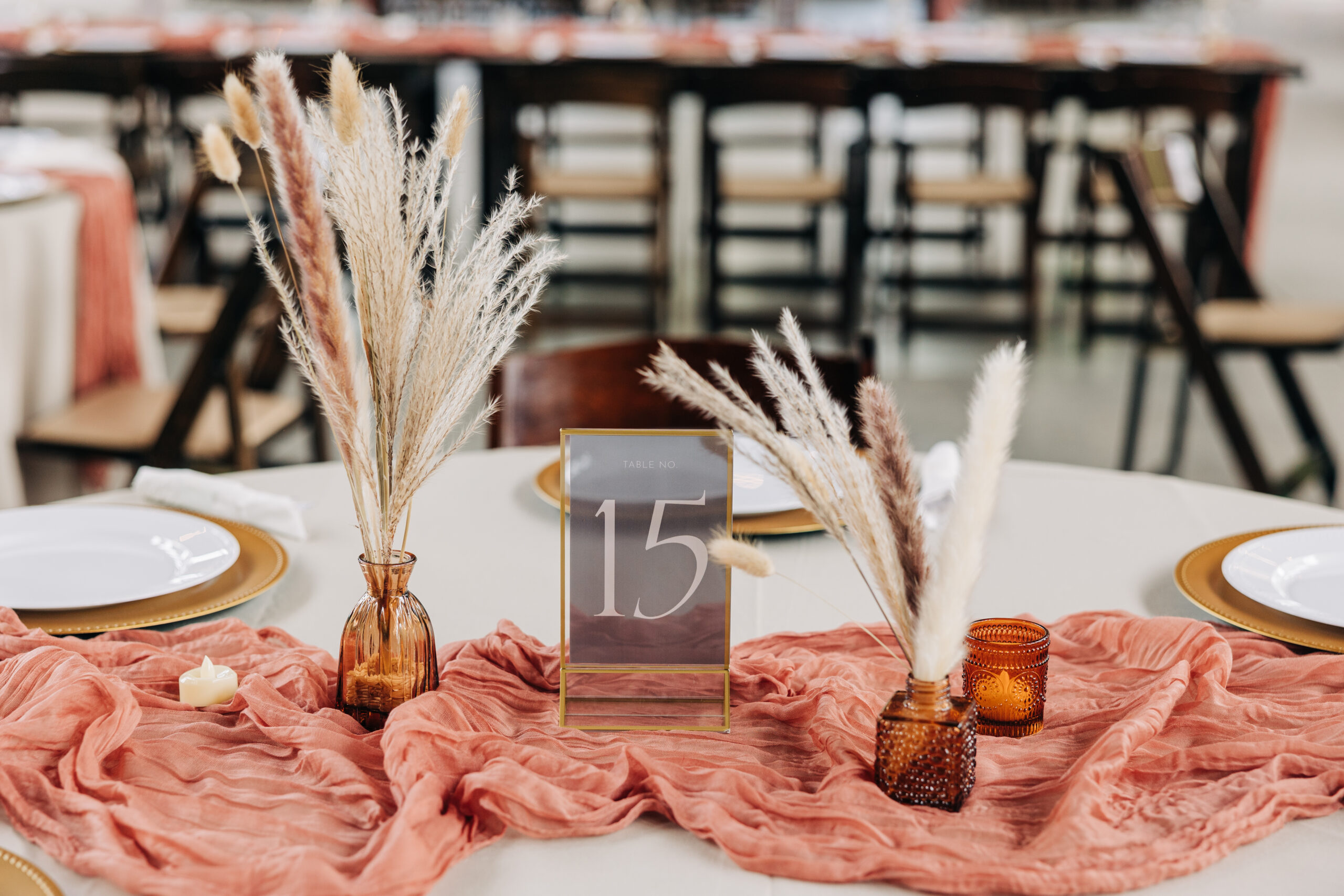 Details of a table setting with pink cloth and boho centerpiece
