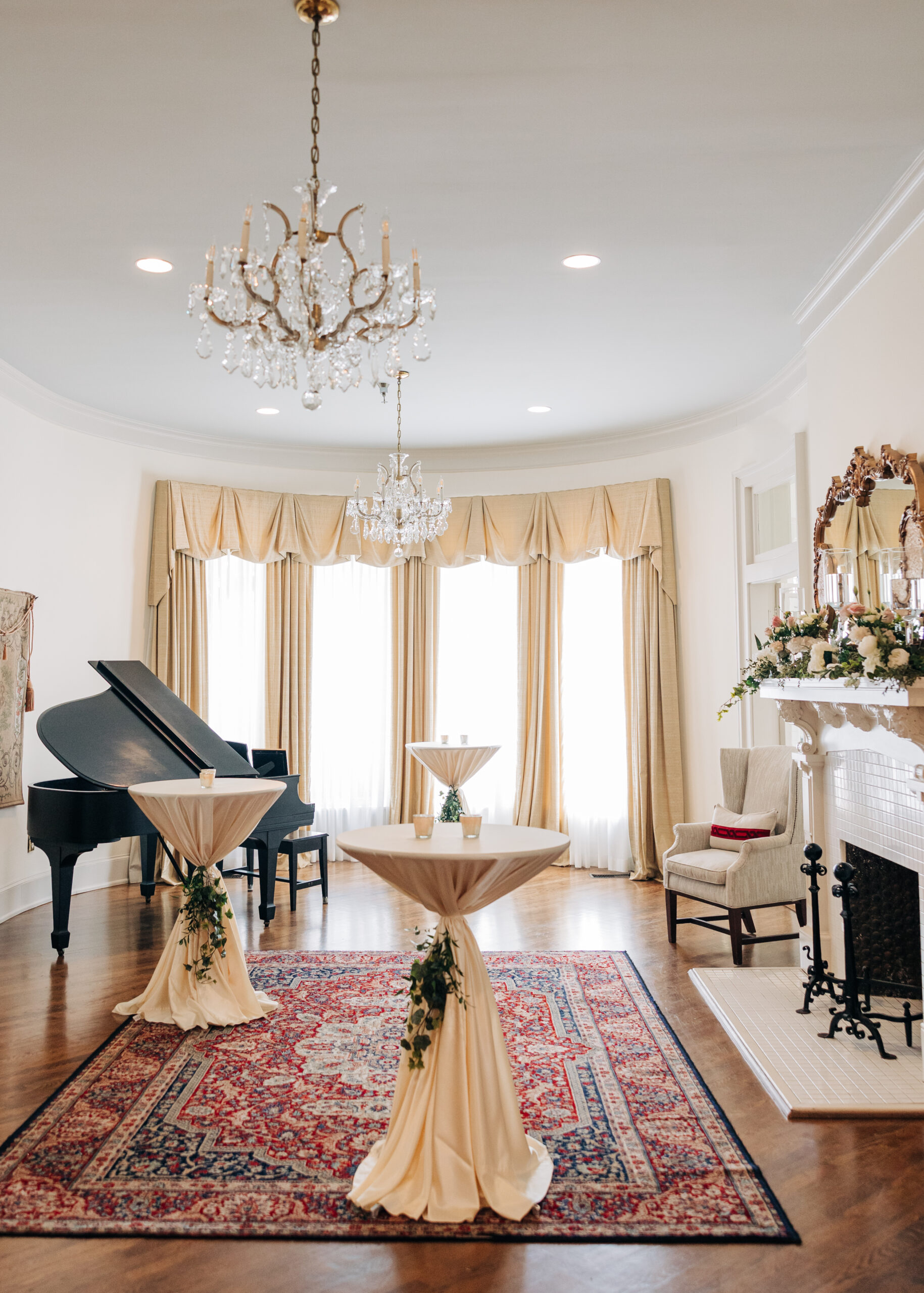 A look into a cocktail hour with a fireplace and piano at a Wimbish House wedding