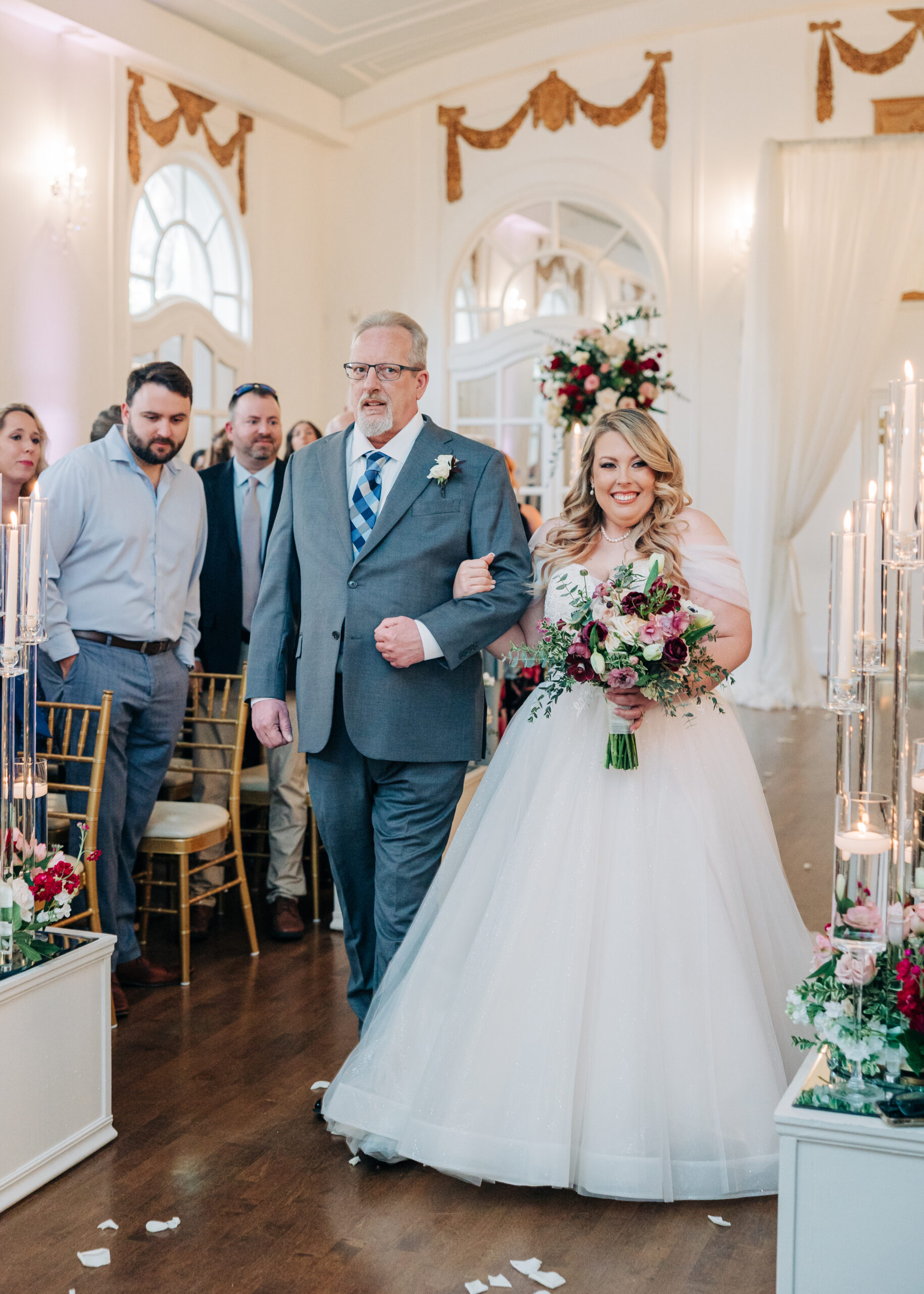 A father walks his daughter down the aisle for her wedding