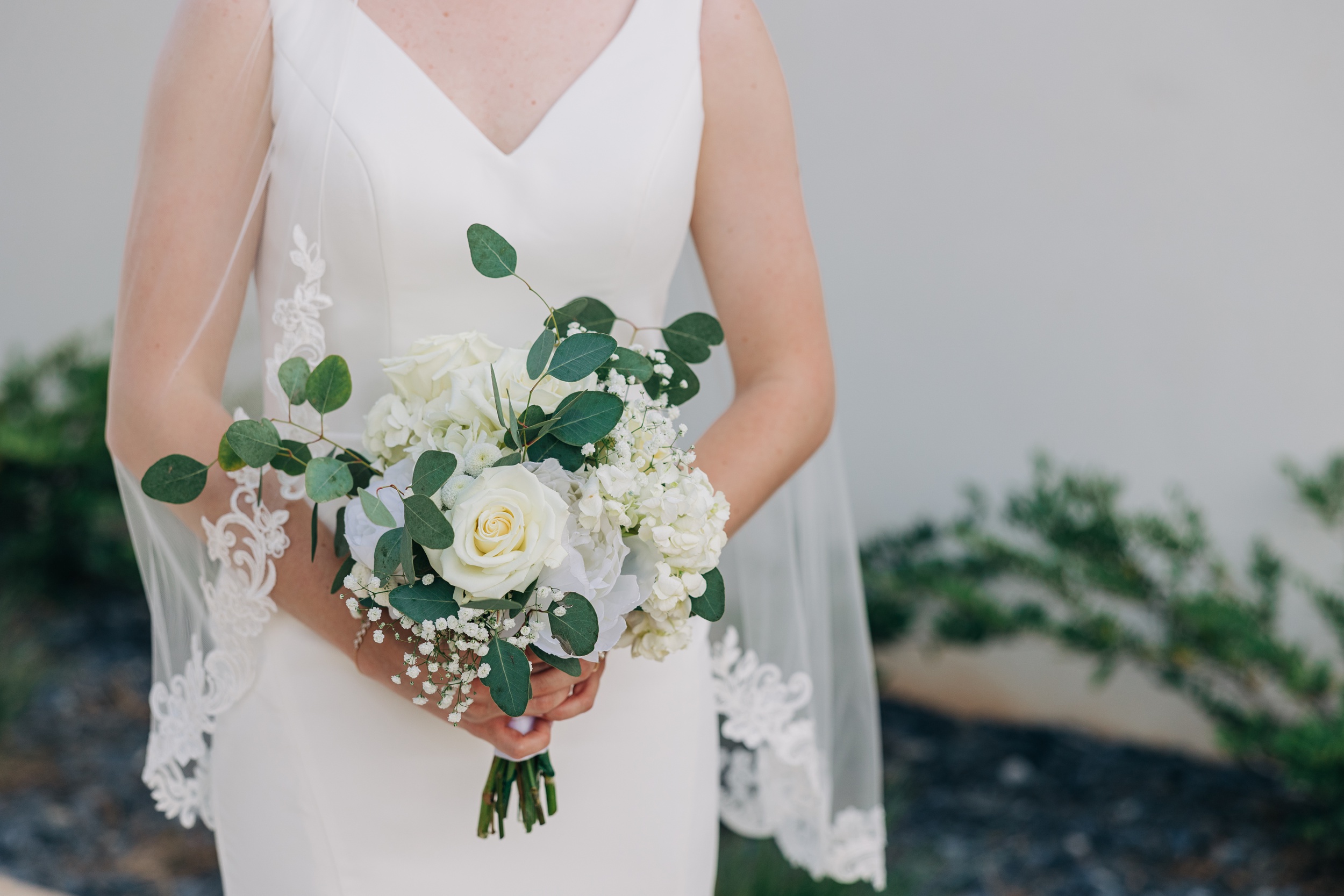 Details of a bride's white rose bouquet