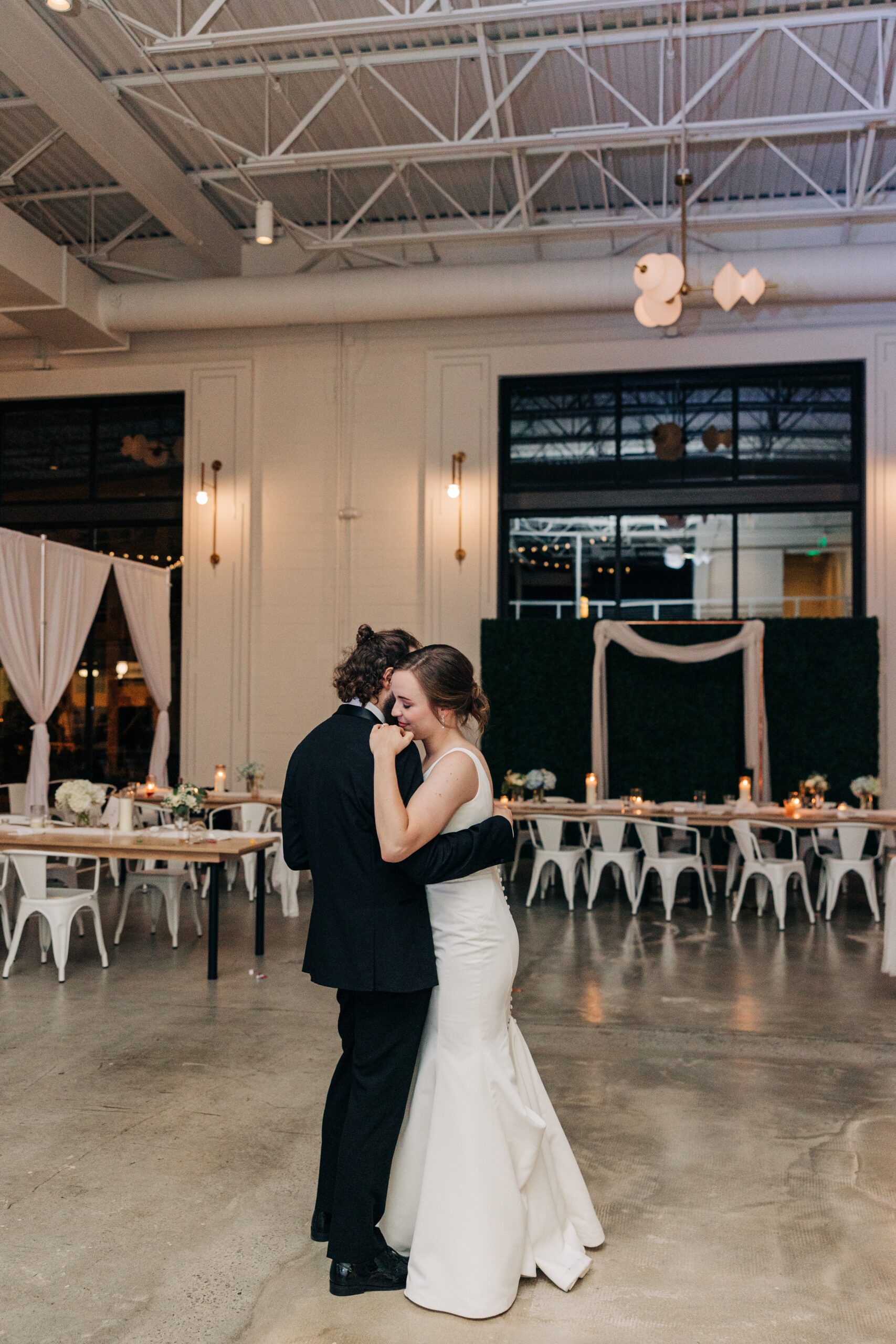 Newlyweds dance in an empty pine wedding venue reception