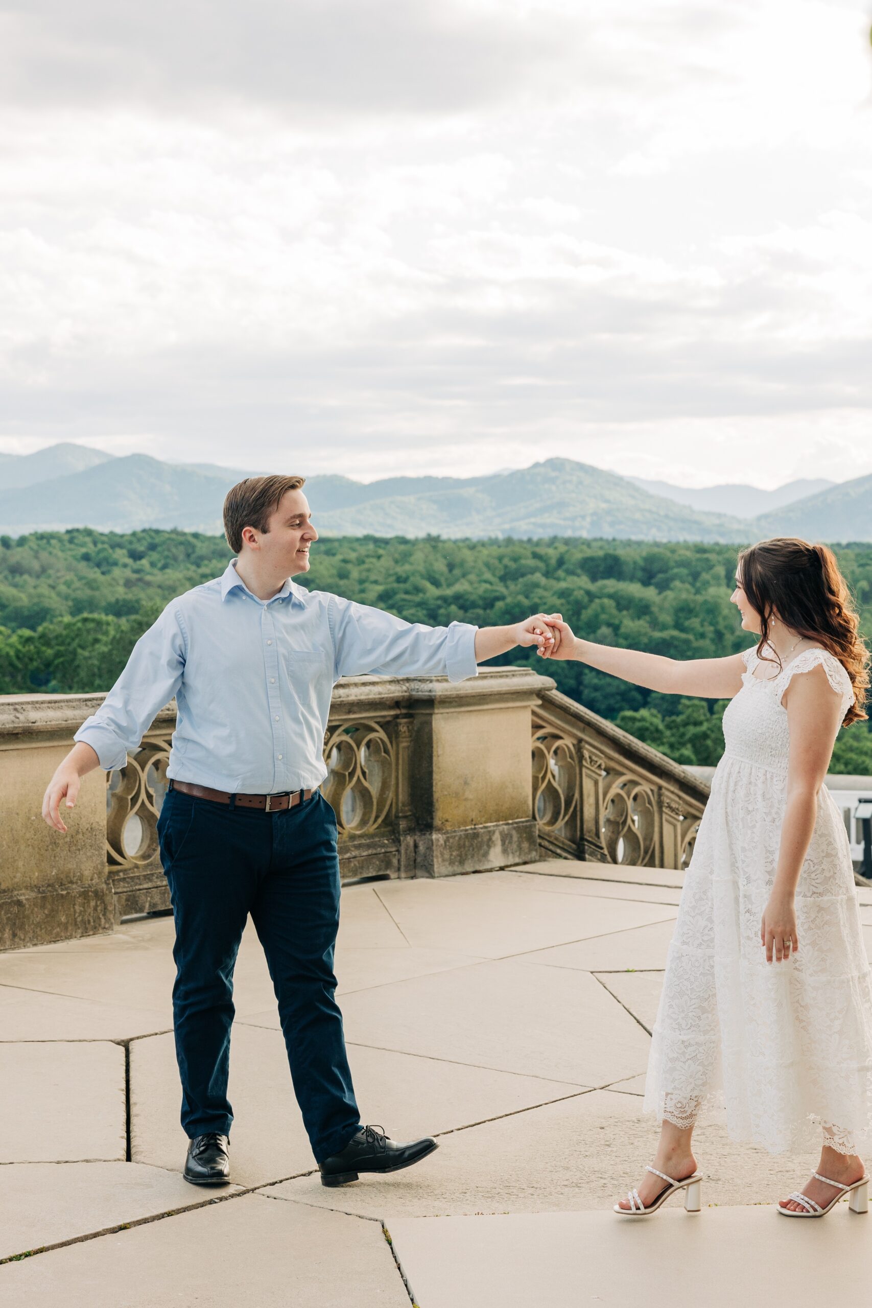 Newlyweds dance on the patio overlooking the mountains during their biltmore estate wedding