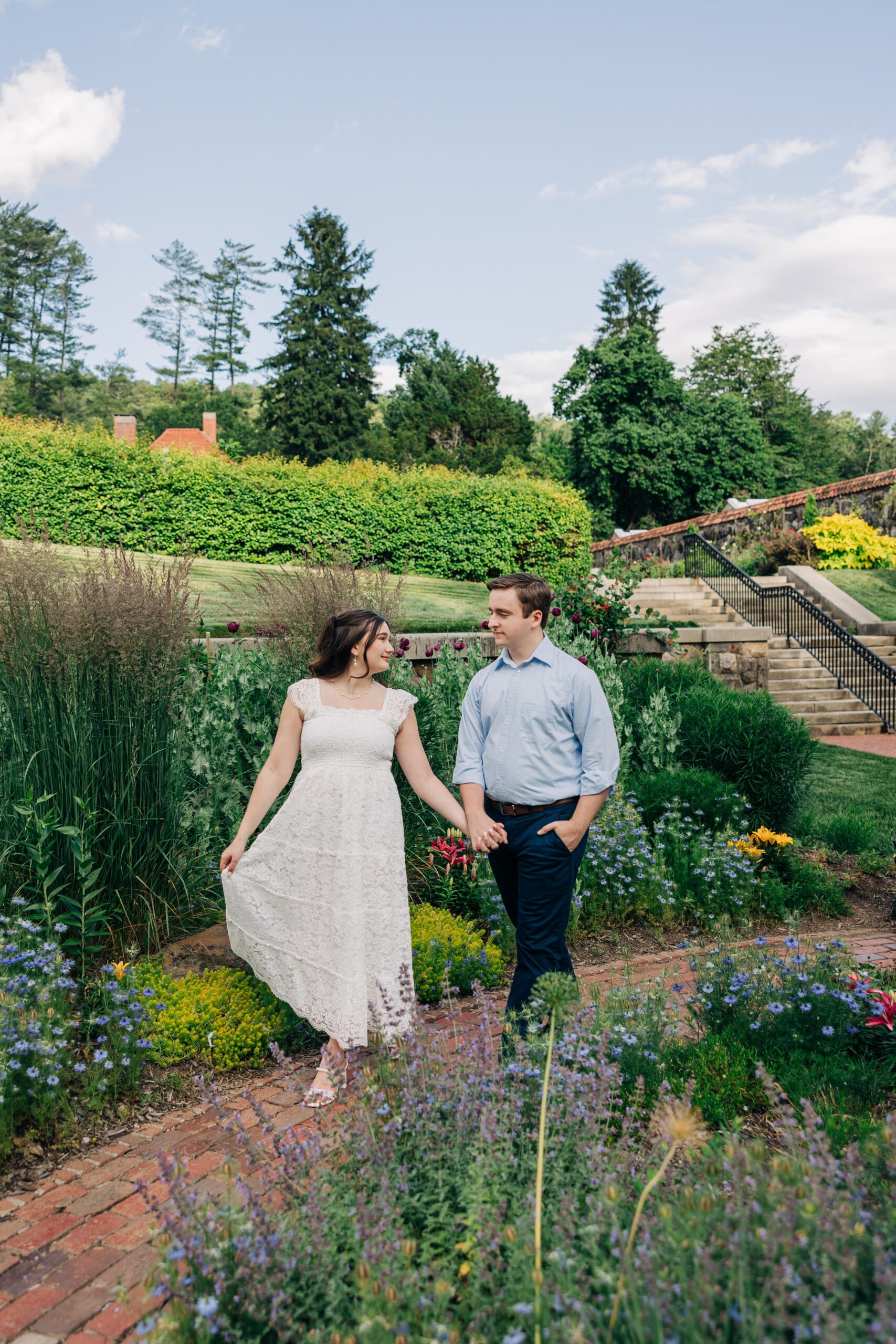 A bride and groom explore a flower garden during their biltmore estate wedding