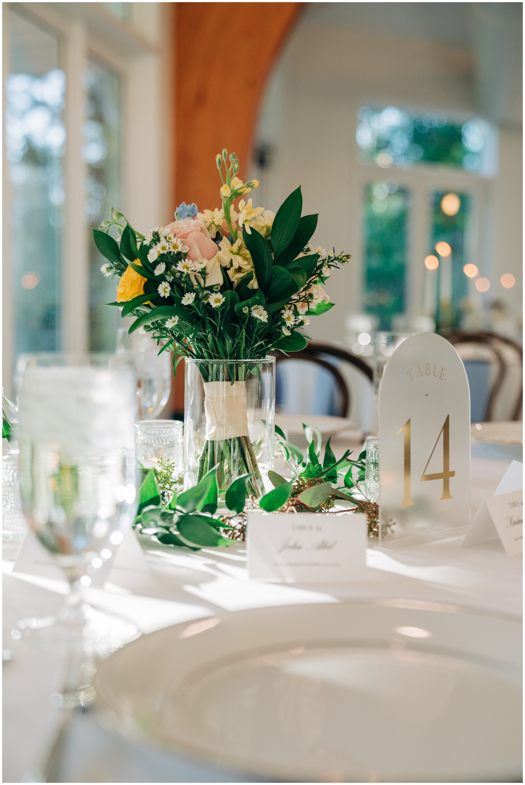 Details of a table setting at the upchurch wedding venue with white linen and colorful florals