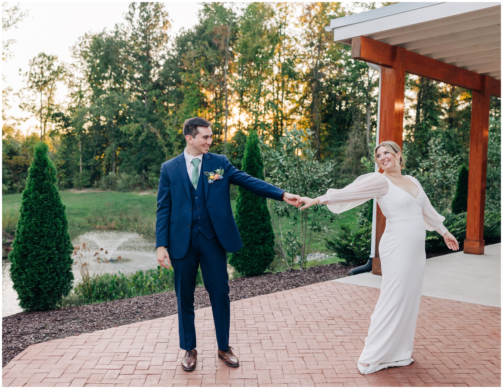 Newlyweds dance and laugh on the brick patio of the upchurch wedding venue at sunset