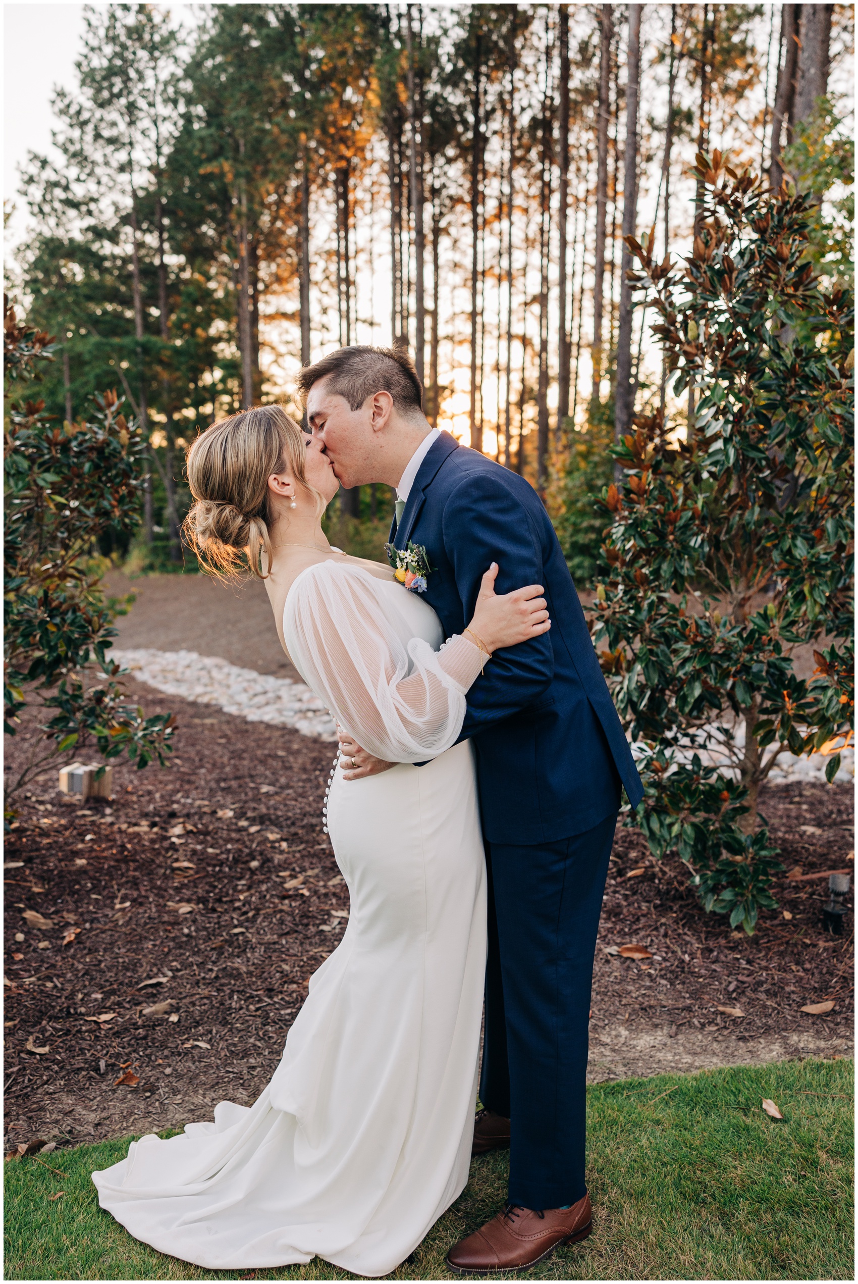 Newlyweds kiss in the garden at sunset at the upchurch wedding venue