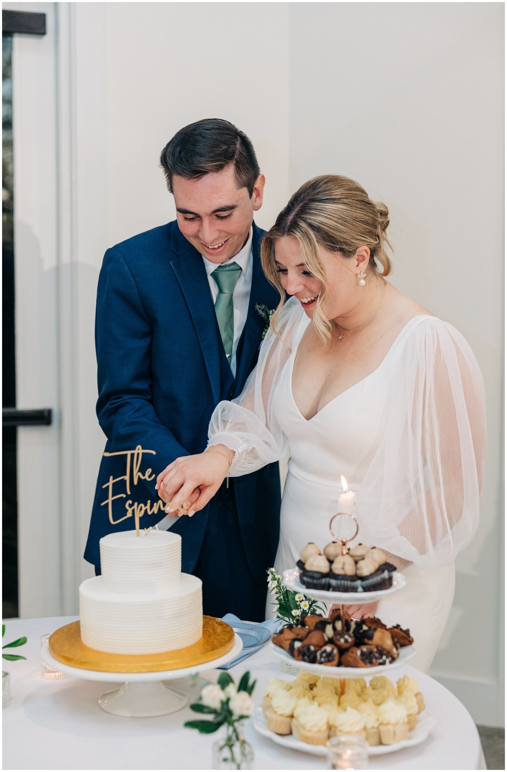 Newlyweds cut the white two tier cake at the upchurch wedding venue