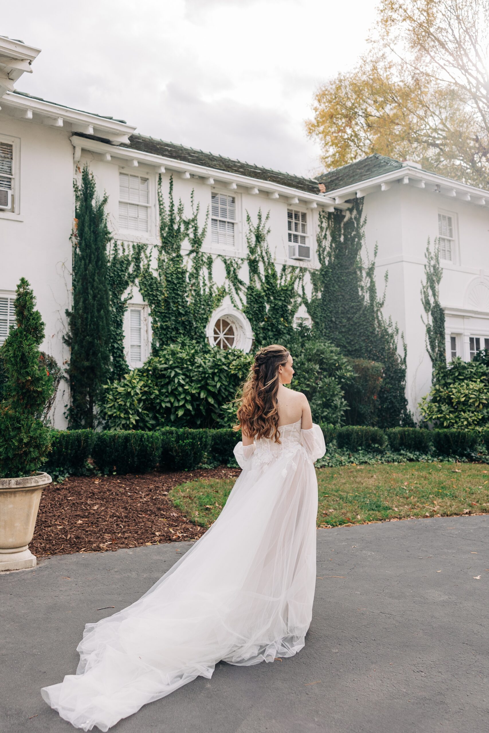 A bride walks in the gardens of her wedding venue