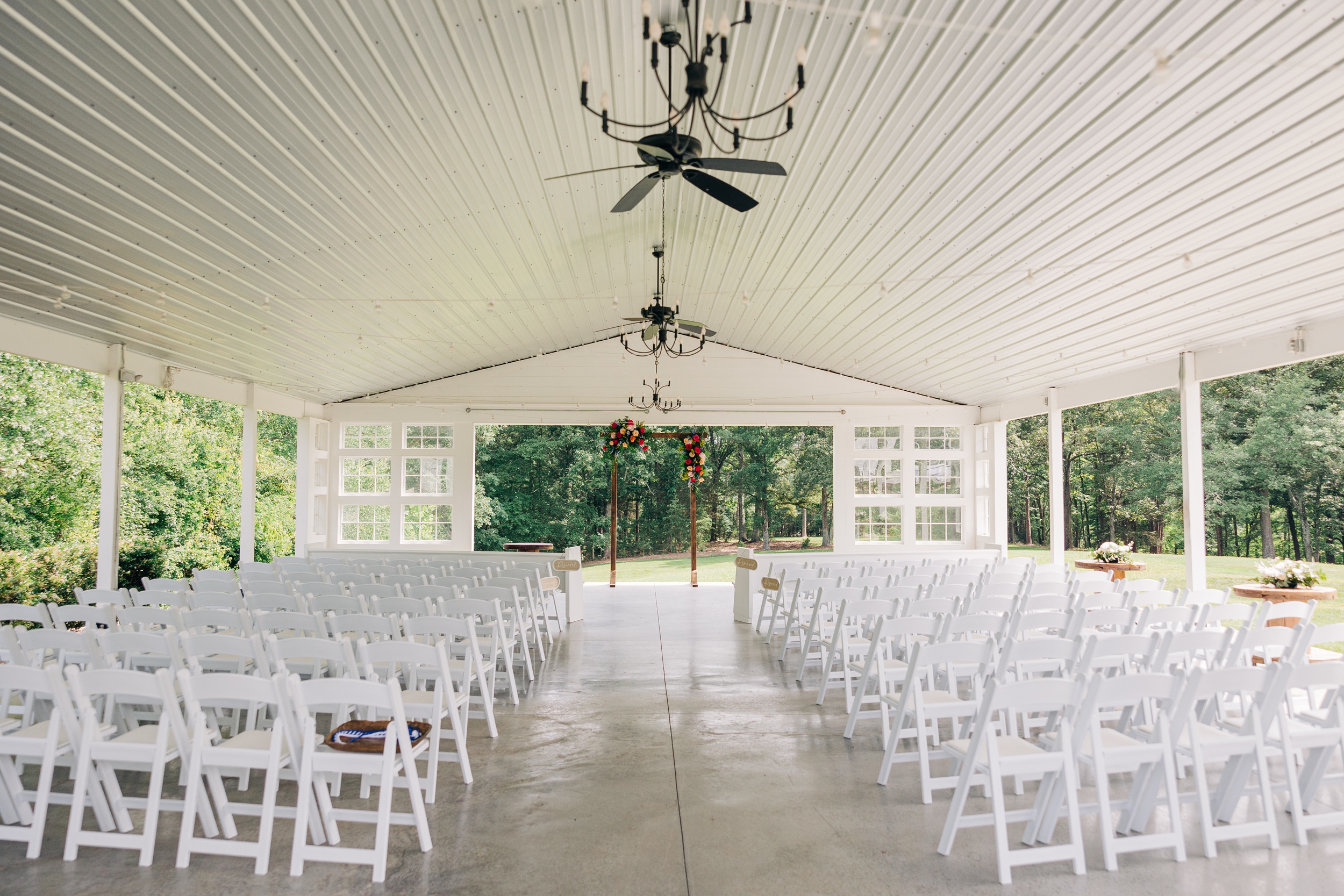 A look down the empty aisle of an open air ceremony at The Ivory Barn