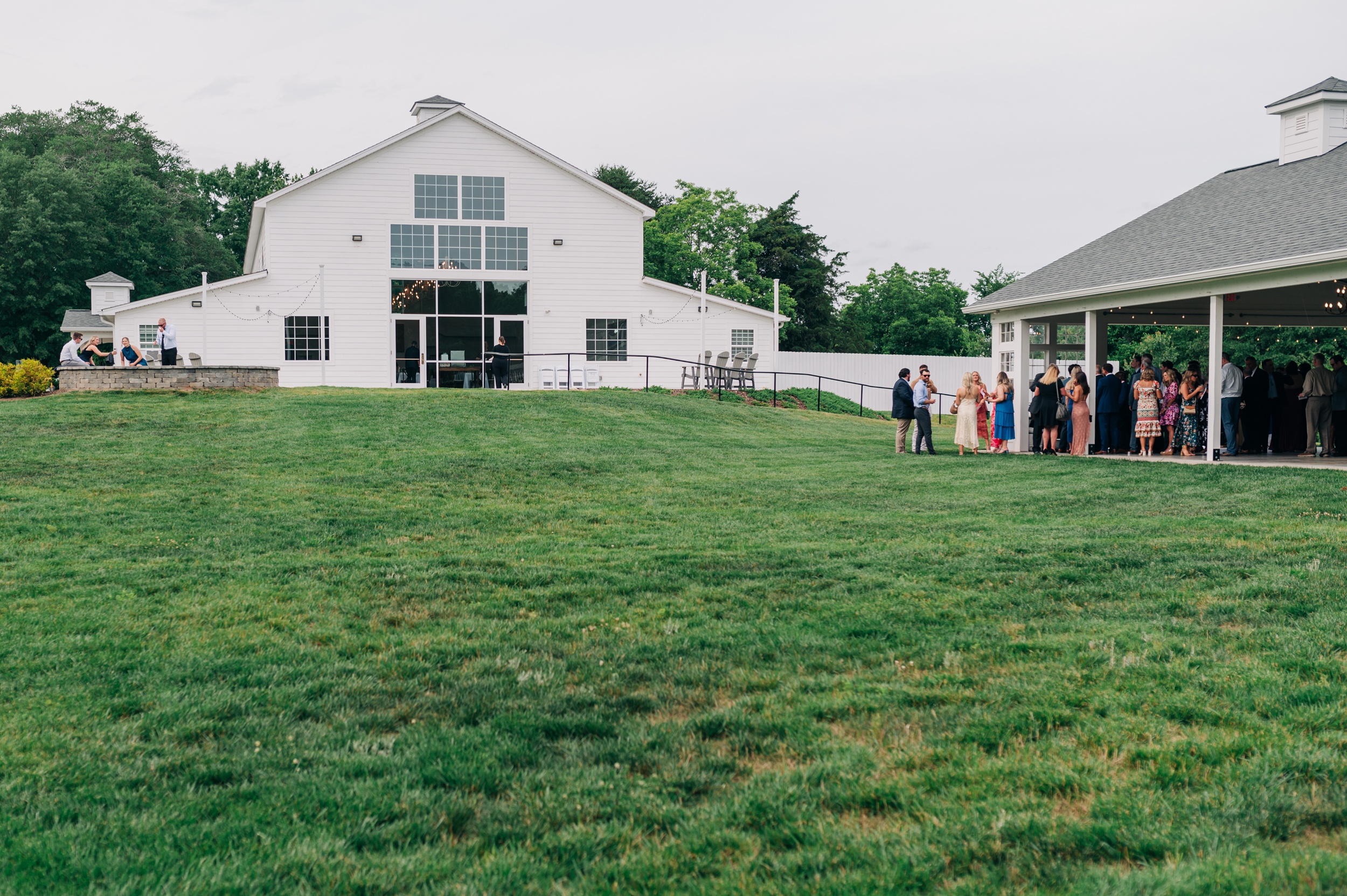 A look at The Ivory Barn lawn and venue locations with active cocktail hour