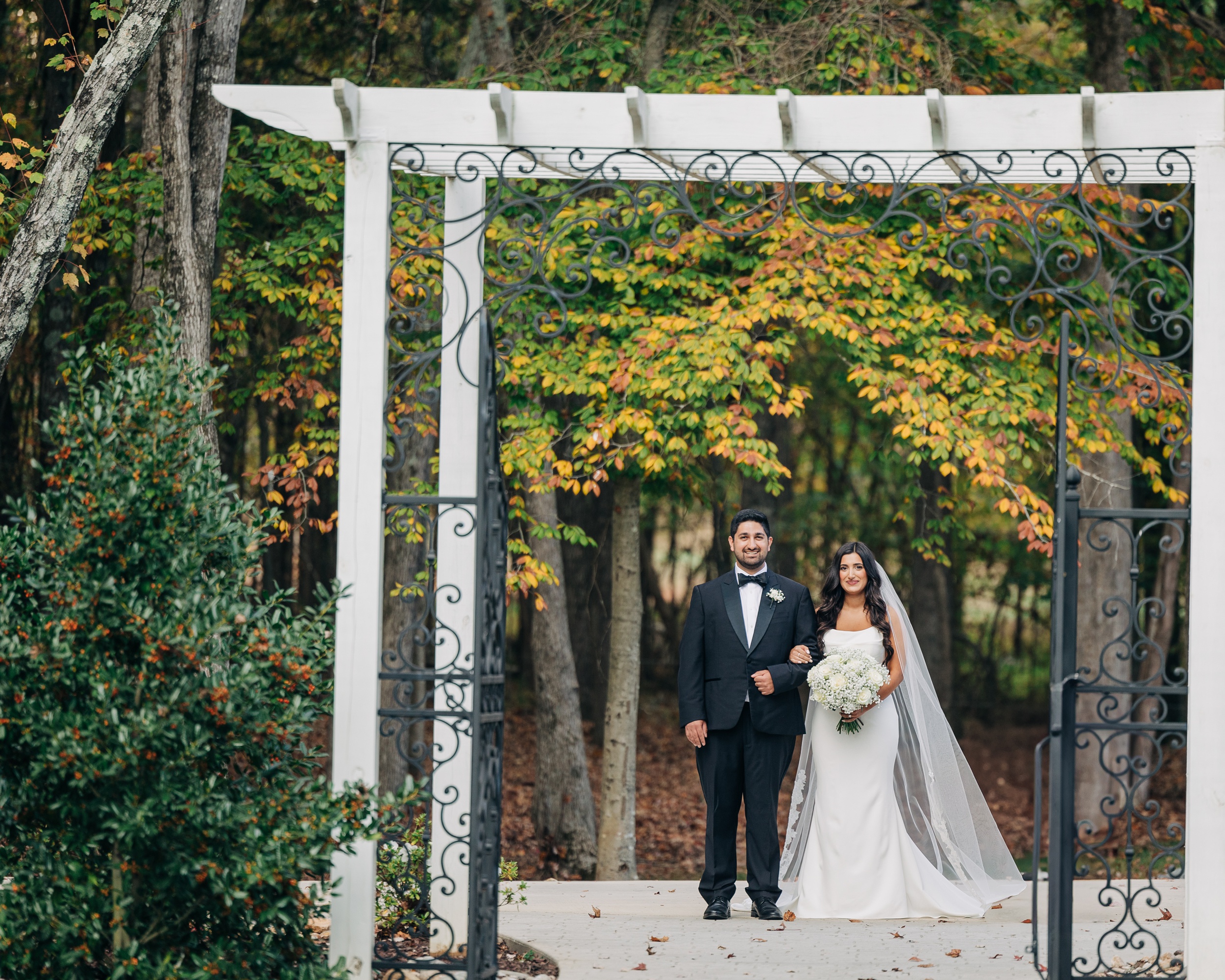 A bride stands with her brother before walking down the aisle at covington gardens