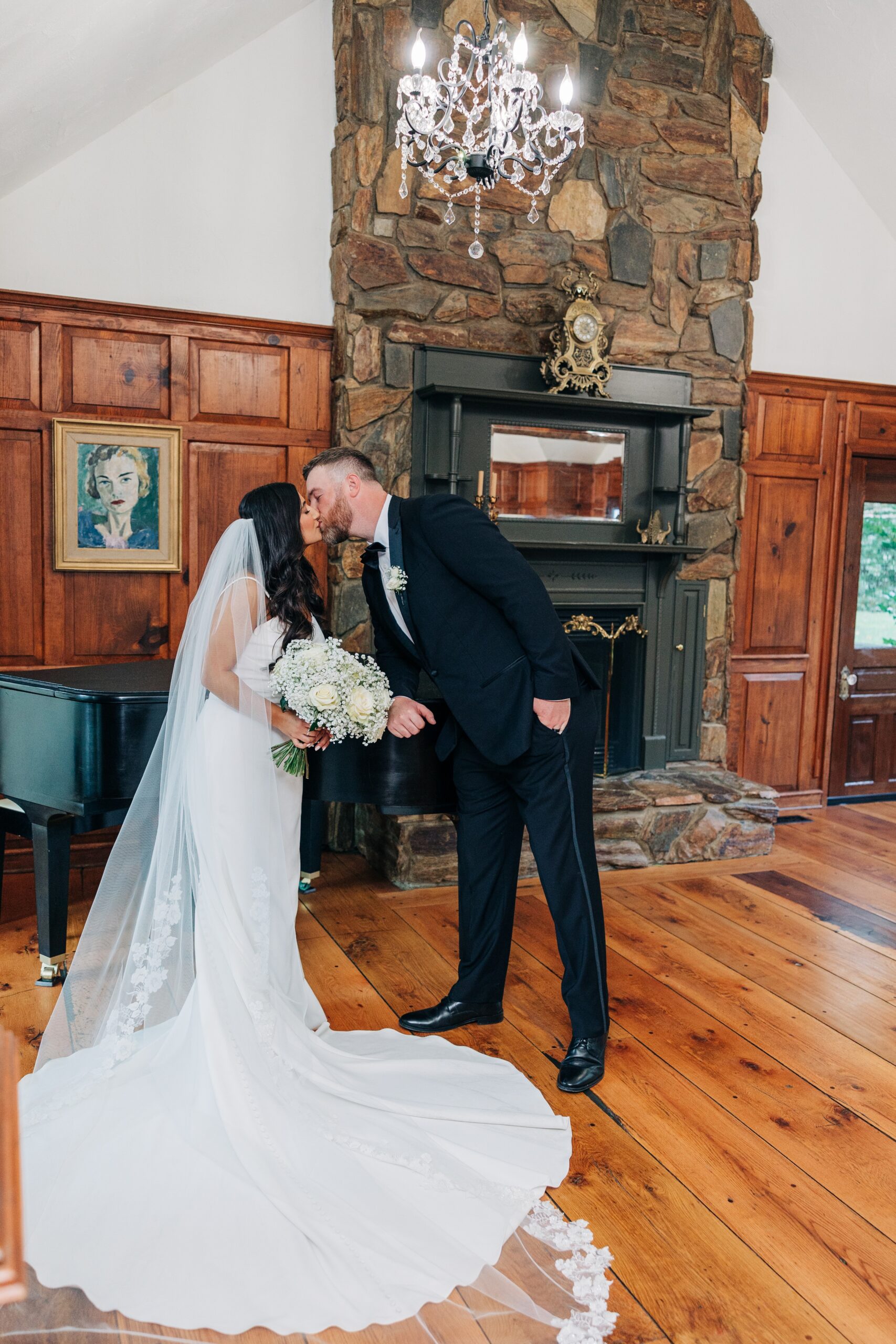 Newlyweds kiss by the fireplace