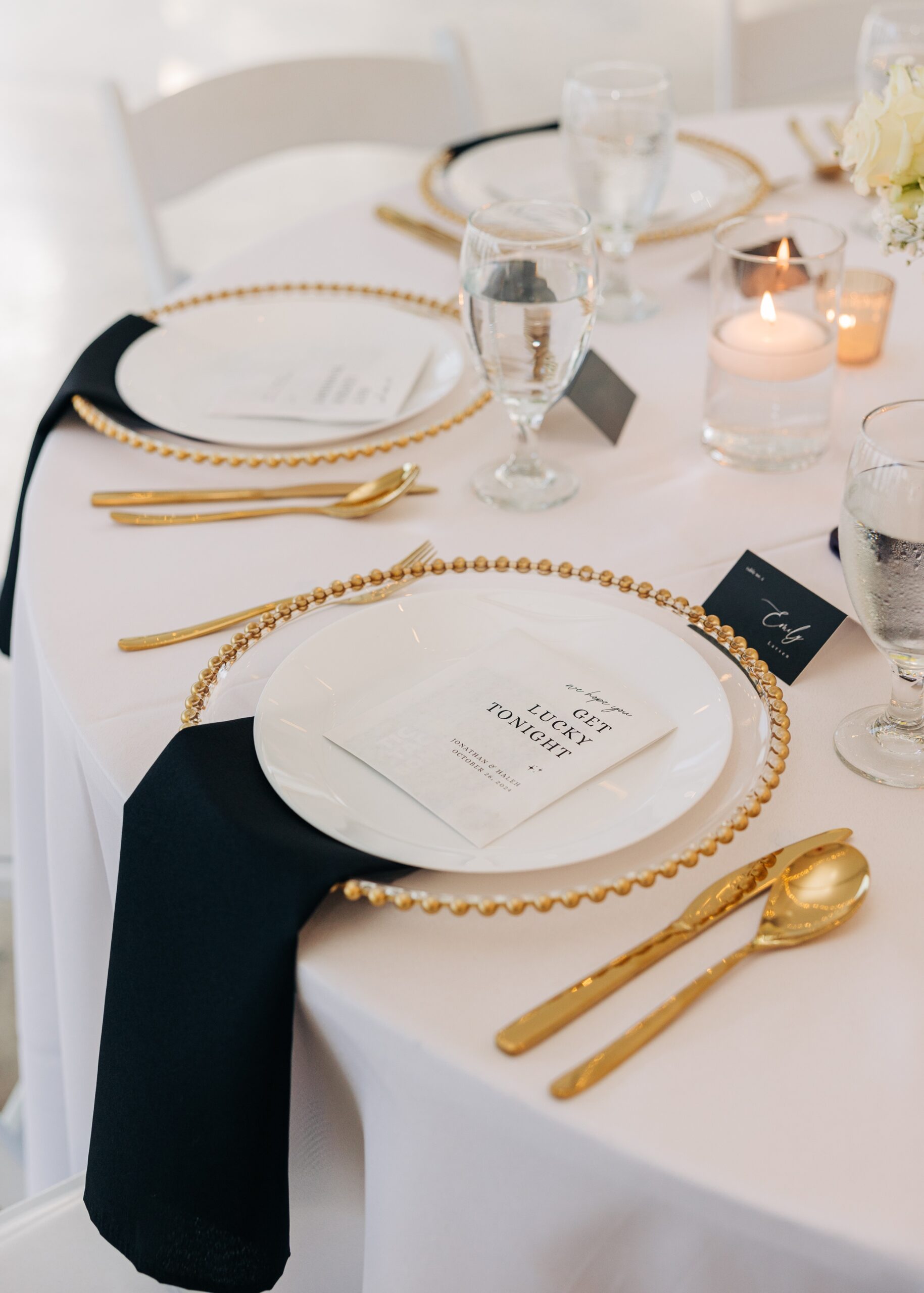 Details of a covington gardens wedding reception table setting with gold utensils