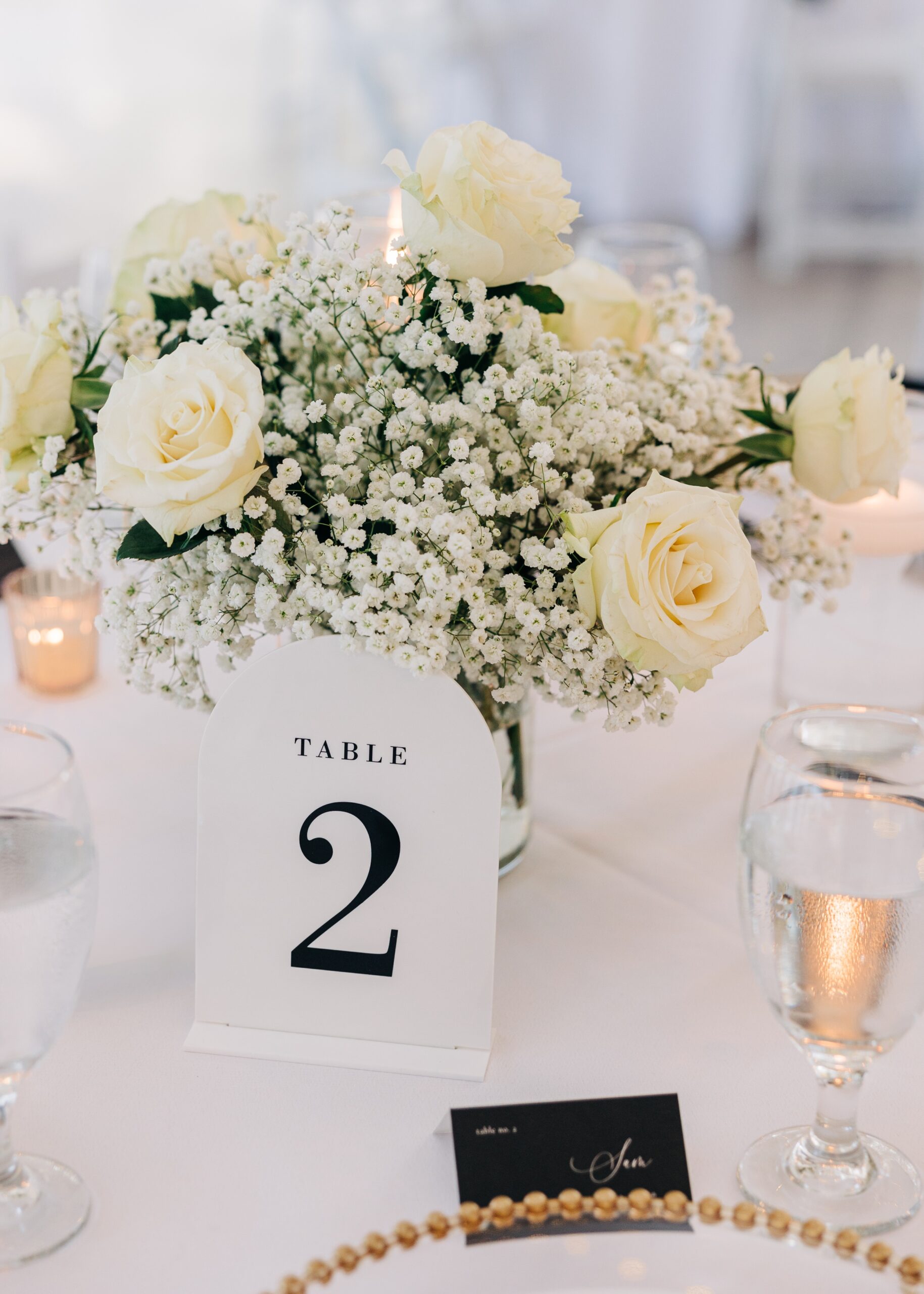 Details of a table setting with white roses