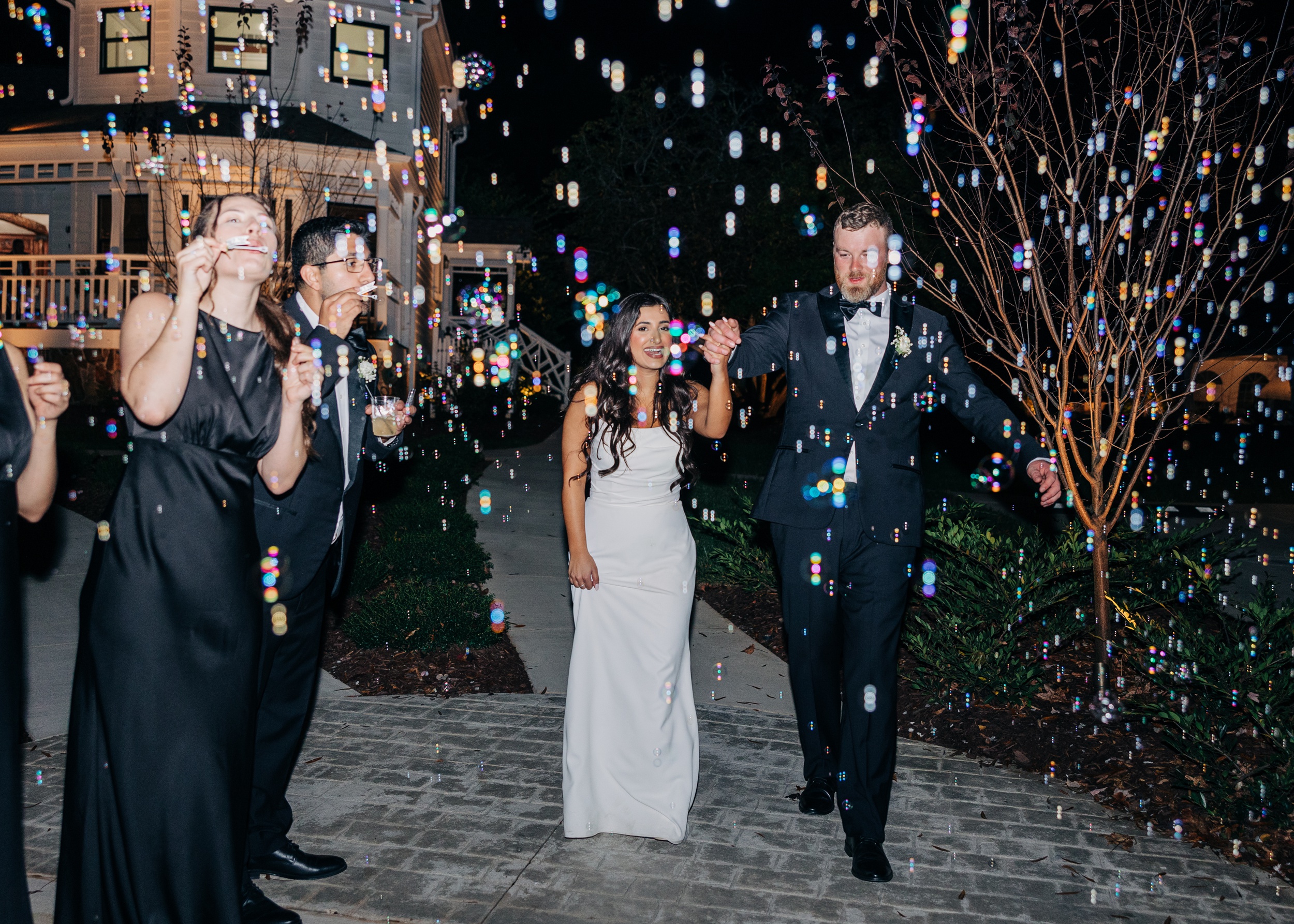 Newlyweds walk through bubbles to leave their covington gardens wedding