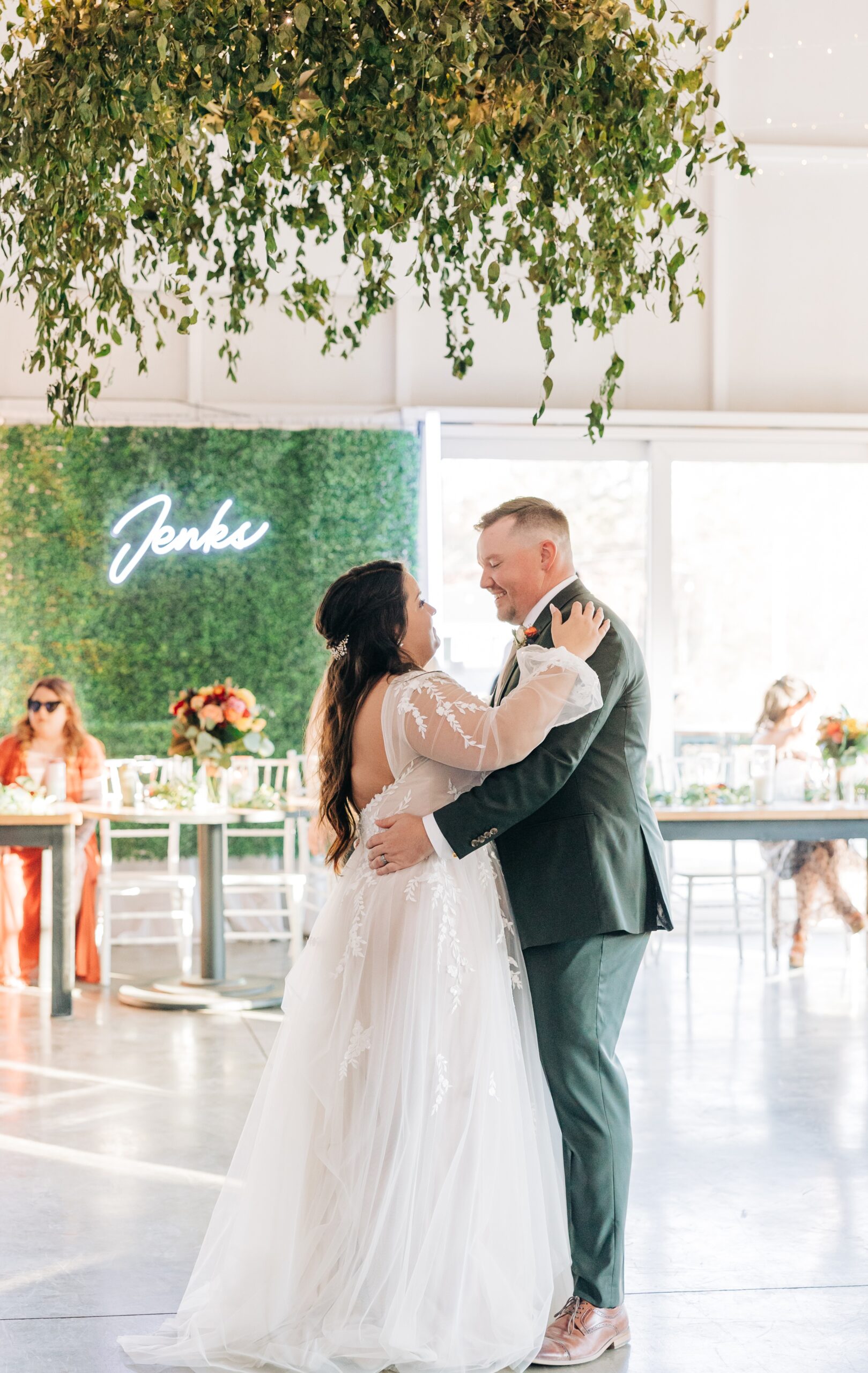 Newlyweds dance for the first time as guests look on