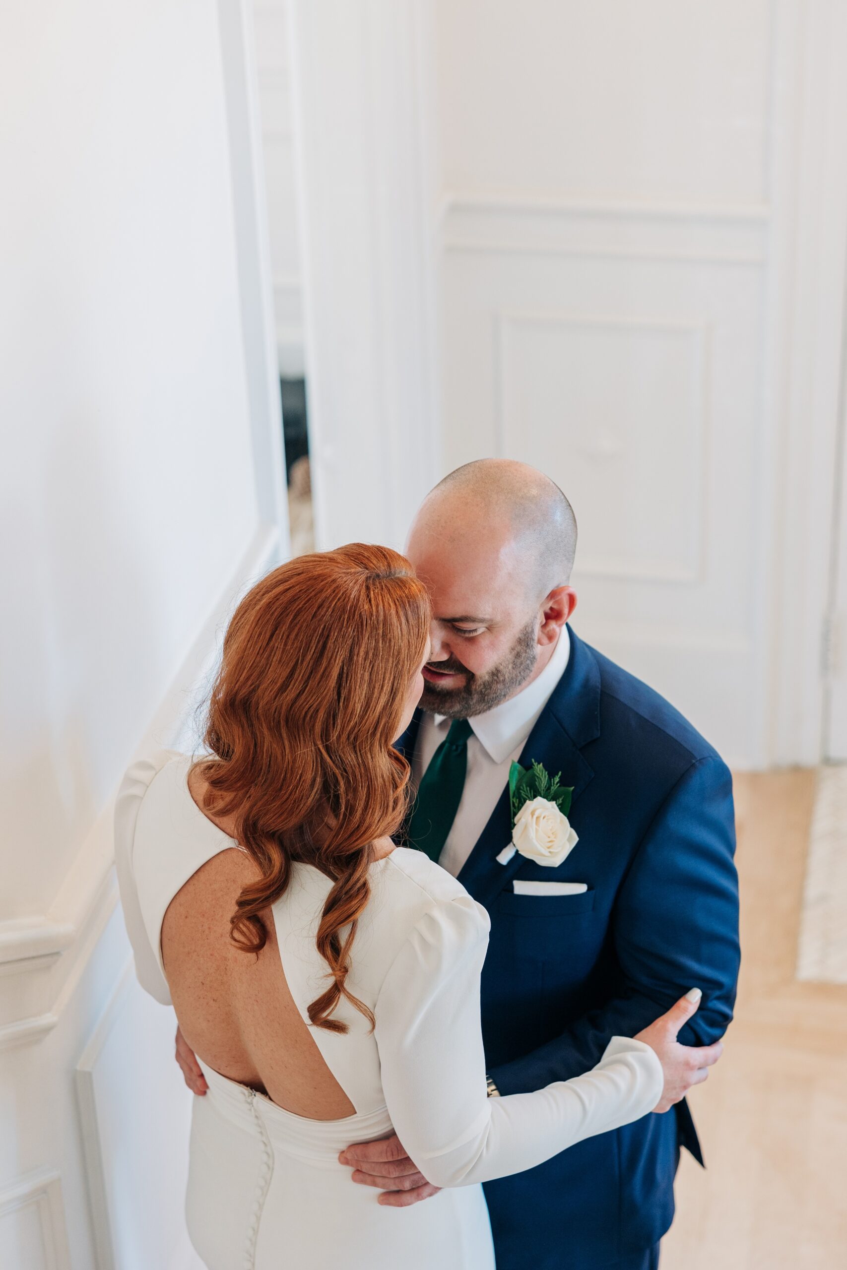 Newlyweds share an intimate moment on the stairs inside the crest winston-salem