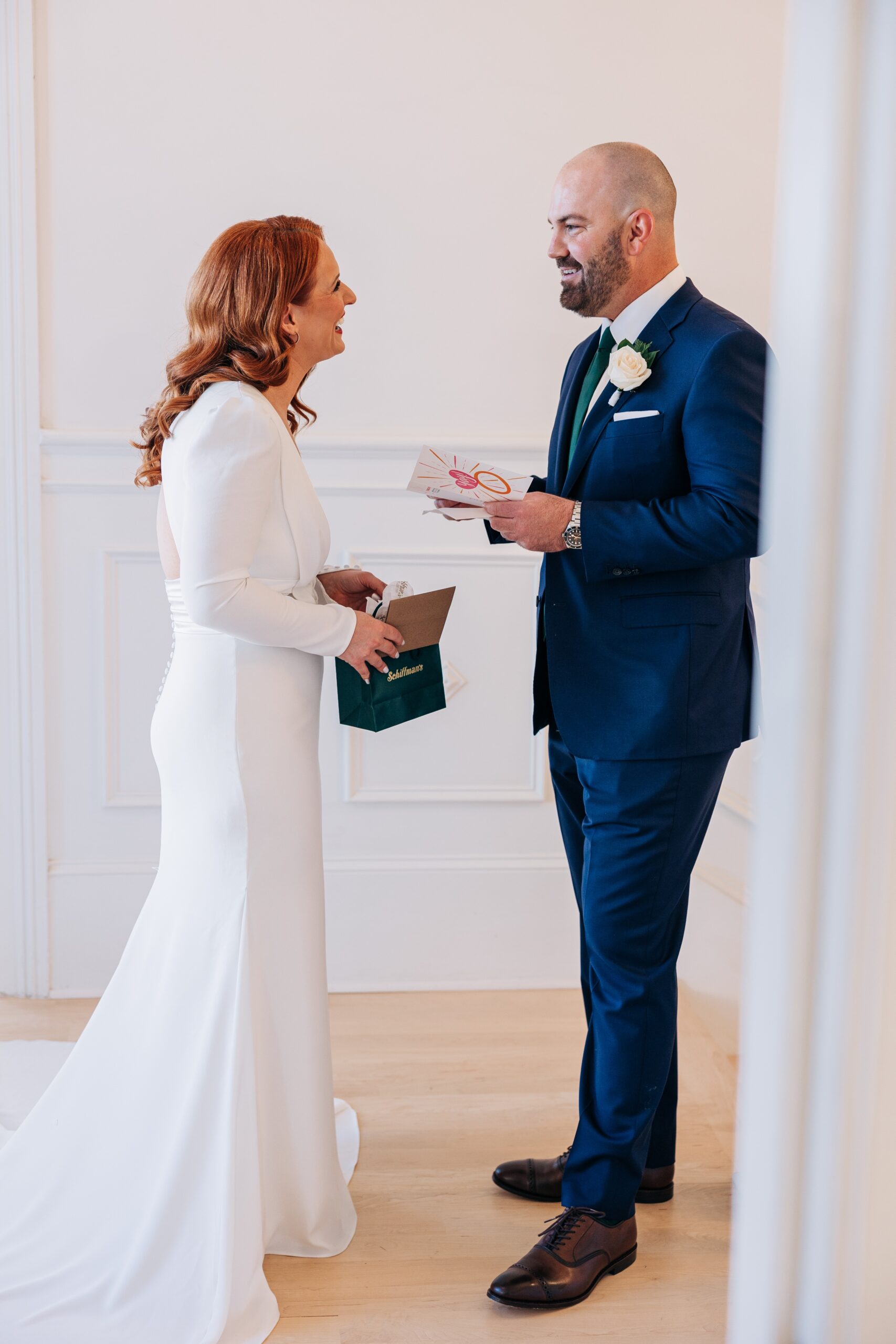 Newlyweds exchange gifts during their first look indoors