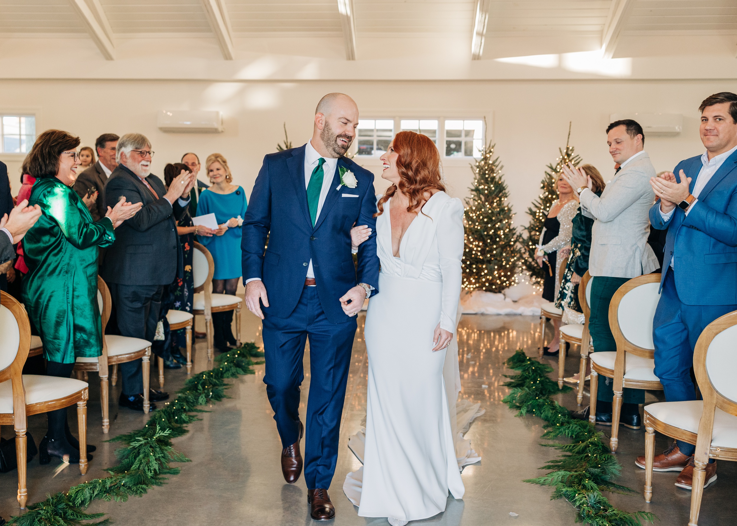 Newlyweds smile at each other while exiting their ceremony at the crest winston-salem