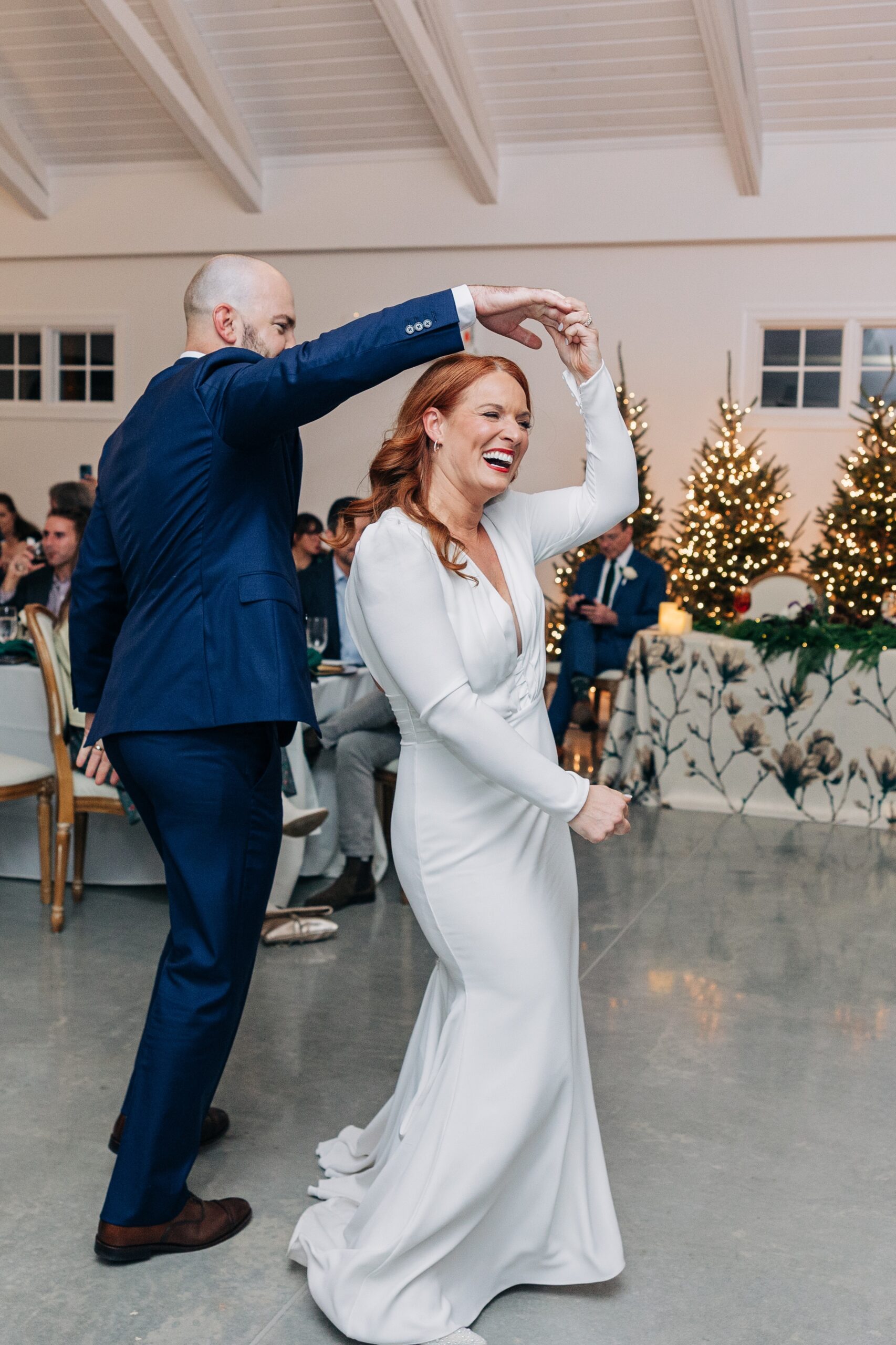 Happy newlyweds dance on the dance floor while laughing