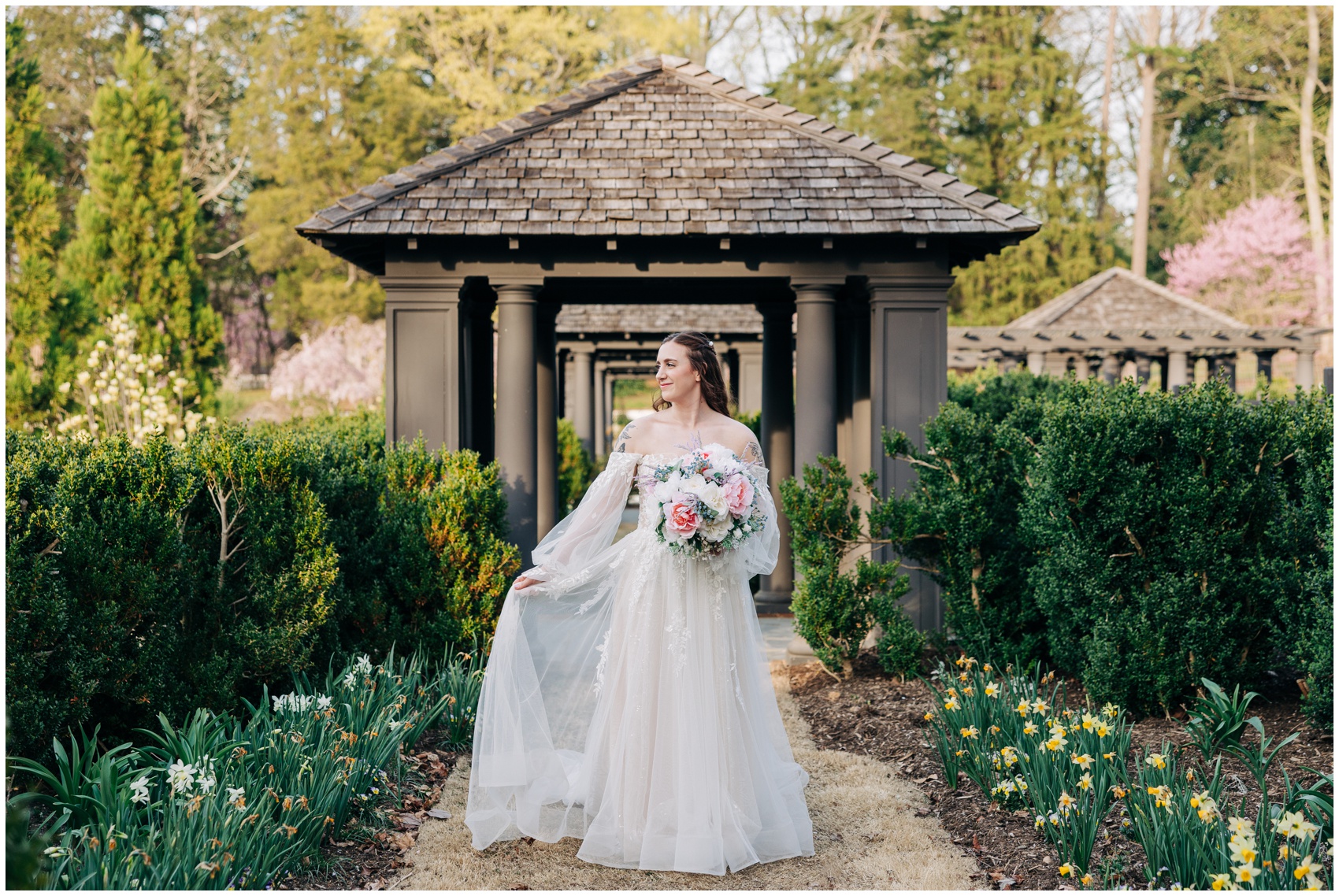 A bride smiles while walking through a tulip garden at one of the most beautiful Winston Salem Wedding Venues
