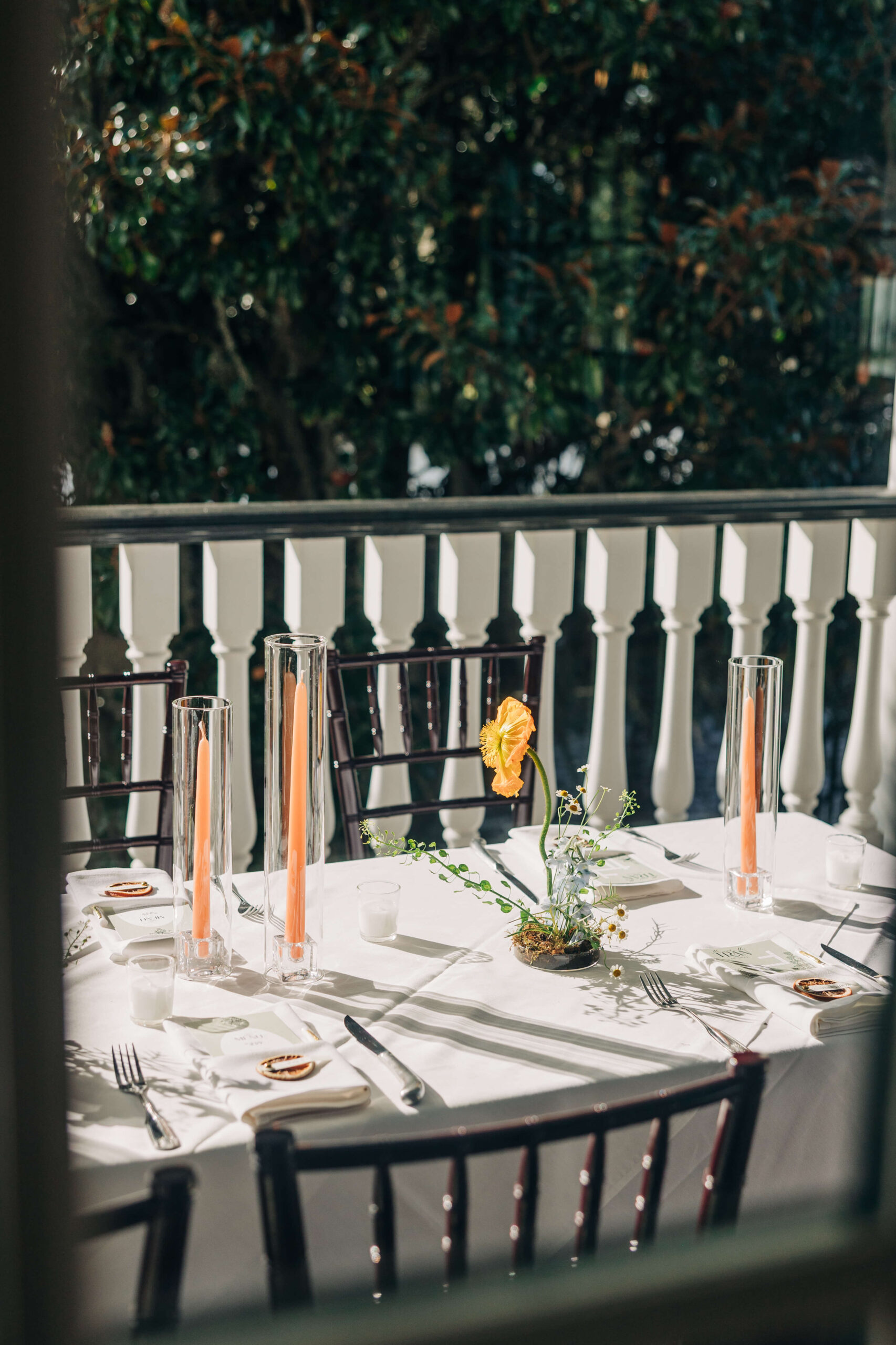 Details looking through a window to an outdoor Dunes West Golf Club wedding reception table